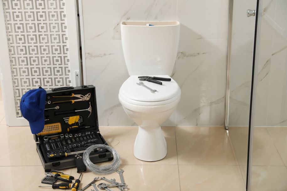 toilet with plumbers tool